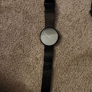 Handcrafted watch . Man or women’s . Black and the face is brown.